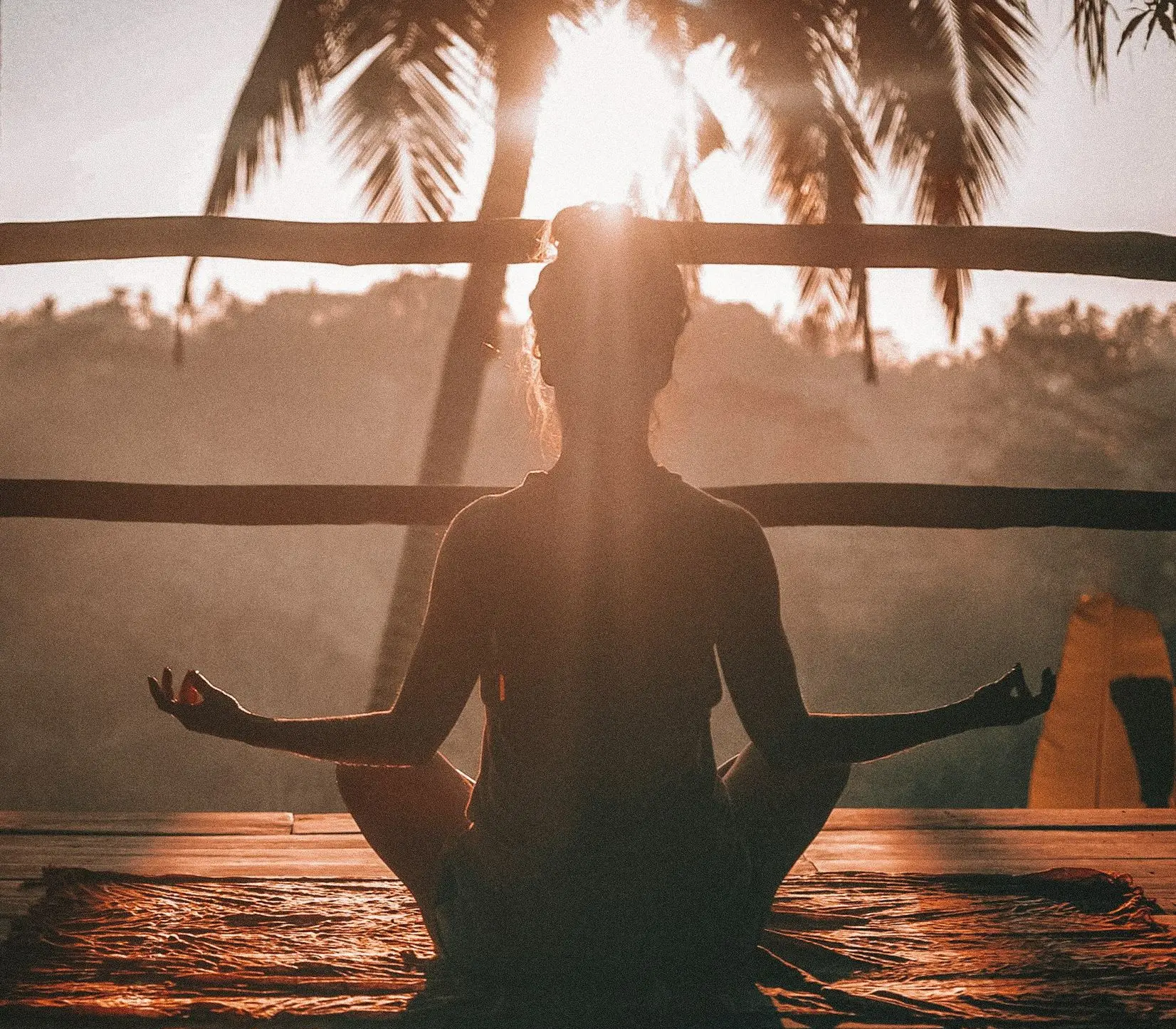 woman doing yoga meditation on brown parquet flooring
