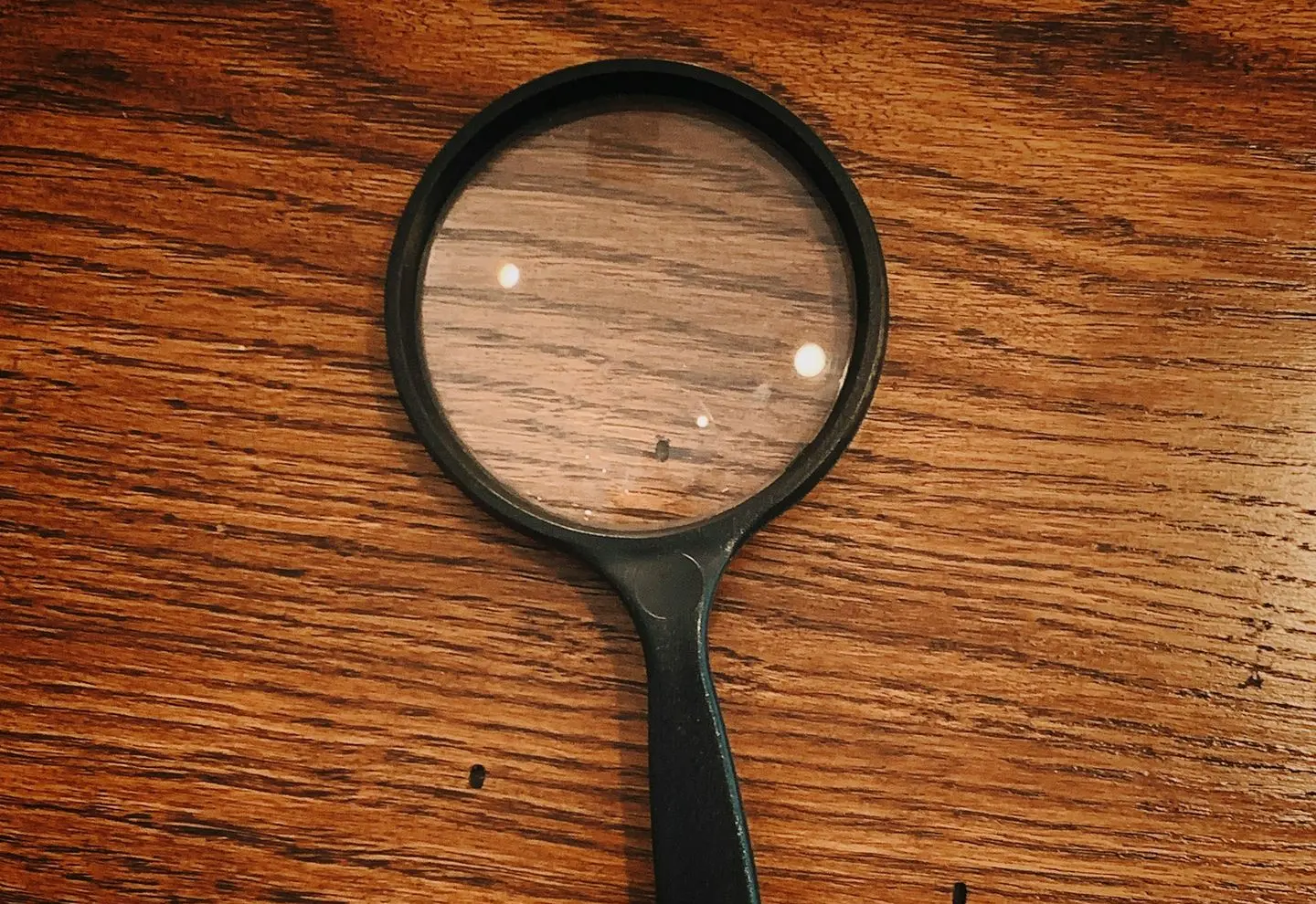 black framed magnifying glass